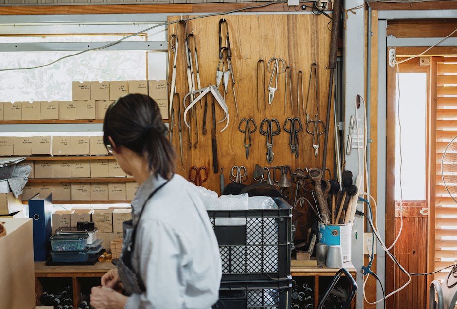 A craftsman working inside a traditional workshop in Nagano, Japan, surrounded by tools and materials.