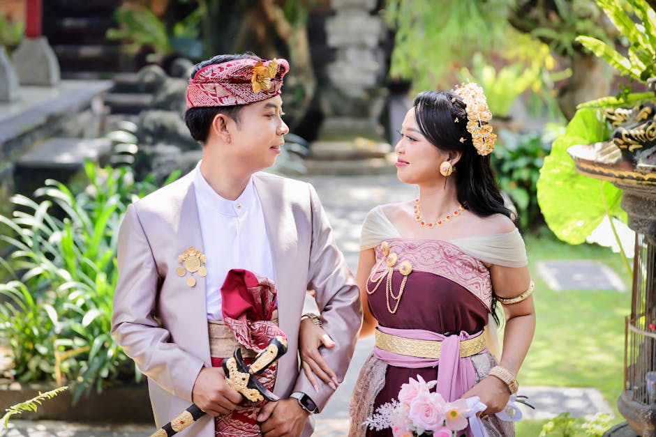 Balinese couple in traditional attire at a ceremony in Nusa Tenggara Barat, Indonesia.