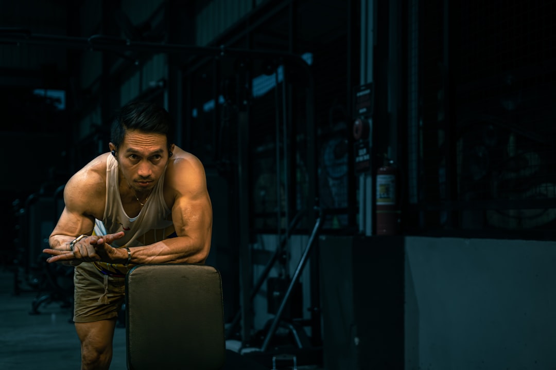 Muscular man rests at the gym.