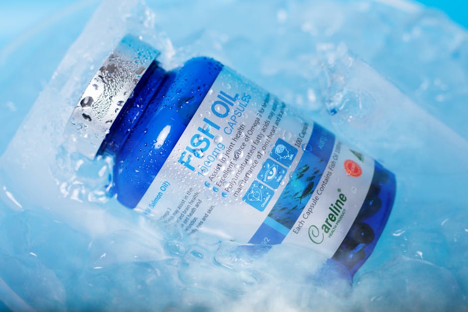 Blue bottle of fish oil capsules nestled in ice, emphasizing freshness and health benefits.