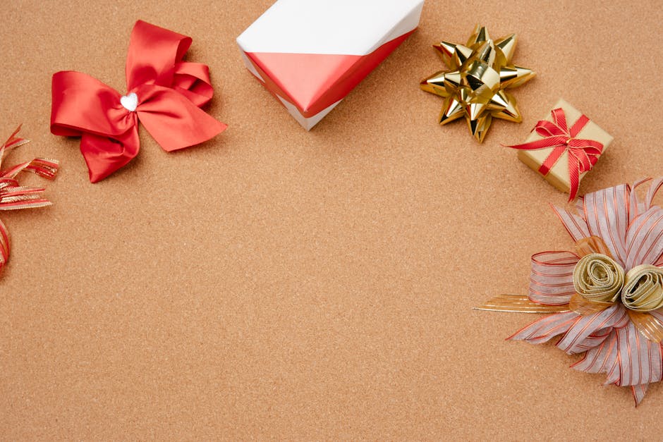 Top view of colorful festive ribbons and gifts on a cork background with copy space.