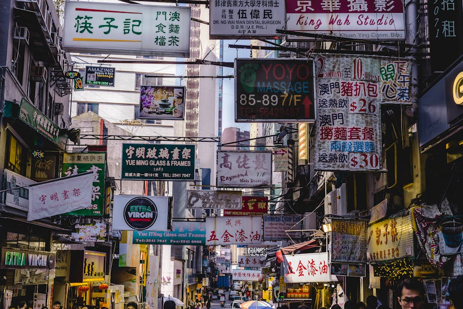 Vibrant urban street filled with numerous bright signs in Hong Kong, showcasing local businesses and culture.