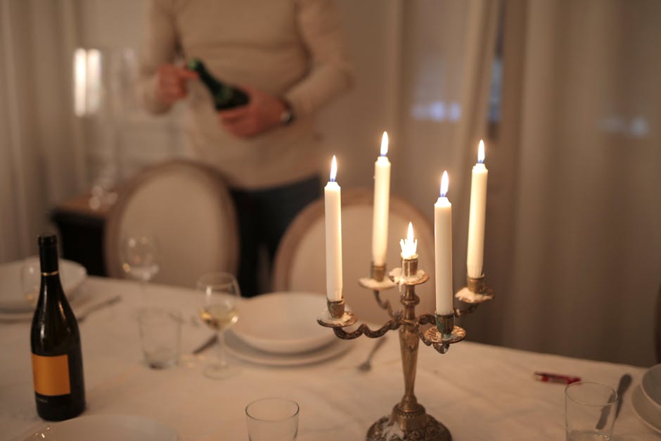A refined candlelit dinner table setup with wine, perfect for intimate gatherings.