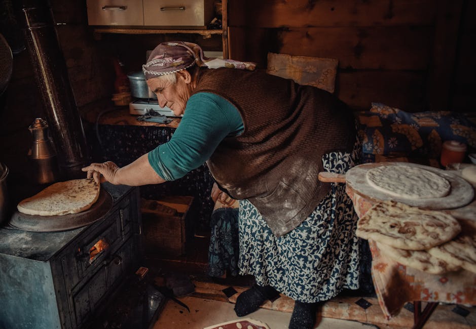 Senior woman baking traditional bread in a cozy Turkish village home, showcasing rustic artisan lifestyle.